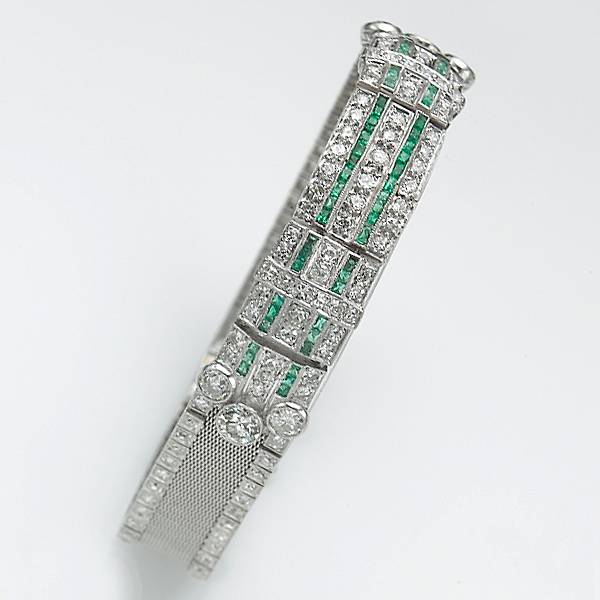 Appraisal: An art deco diamond emerald and platinum mesh bracelet estimated