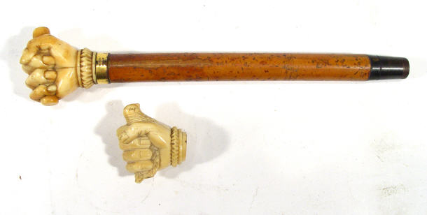 Appraisal: Ivory handled stick the grip carved as a fist clutching