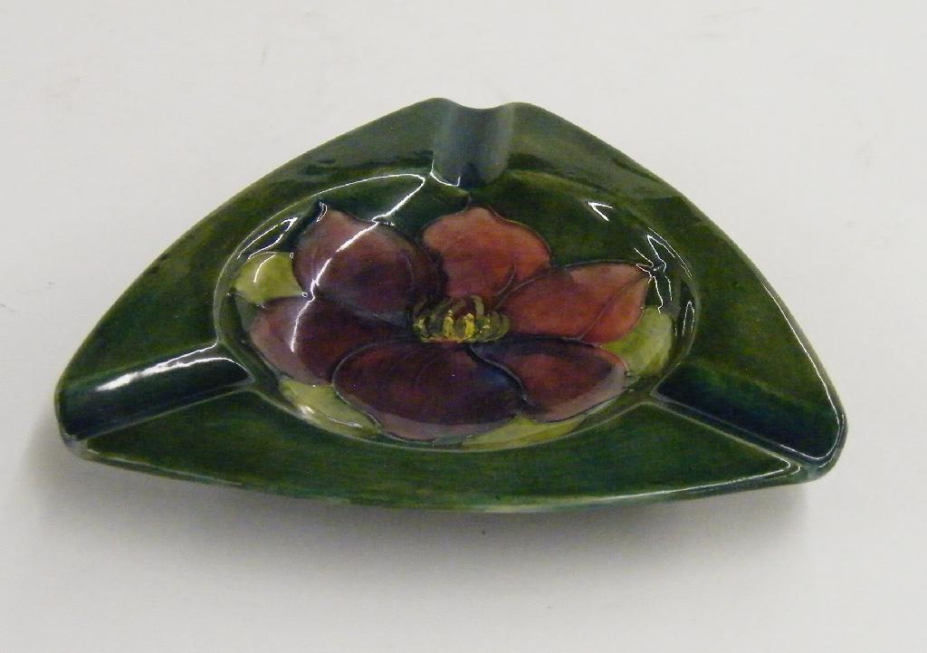 Appraisal: Moorcroft 'Anemone' design triangular ashtray decorated upon a mottled green