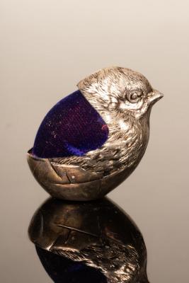 Appraisal: A silver coloured metal chick pin cushion cm wide