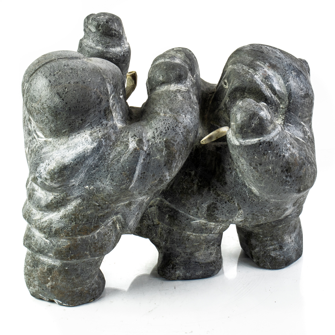 Appraisal: AN INUIT BASALT GROUP OF TWO ESKIMOS SMOKING An Inuit