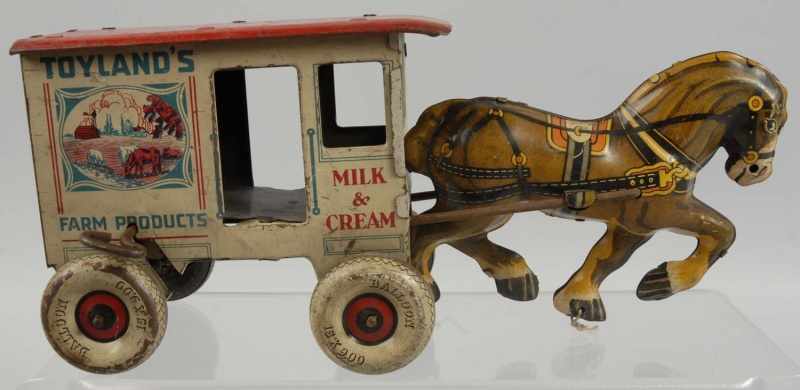 Appraisal: Tin Litho Toyland Milk Cream Wagon Toy Description Horse-drawn Some