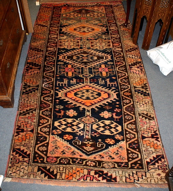 Appraisal: A KASAK BROWN GROUND RUG decorated an interlinked pattern of