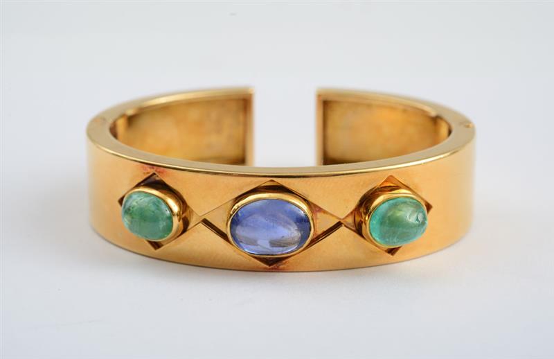 Appraisal: K GOLD SAPPHIRE AND EMERALD BANGLE BULGARI Polished gold hinged