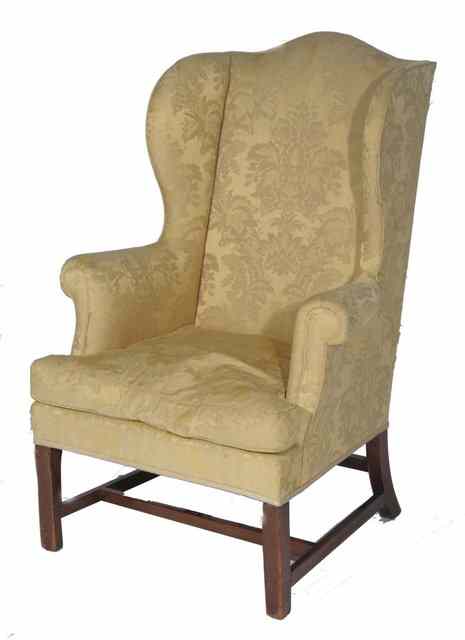 Appraisal: A GEORGIAN MAHOGANY FRAMED WING CHAIR with shaped arms and