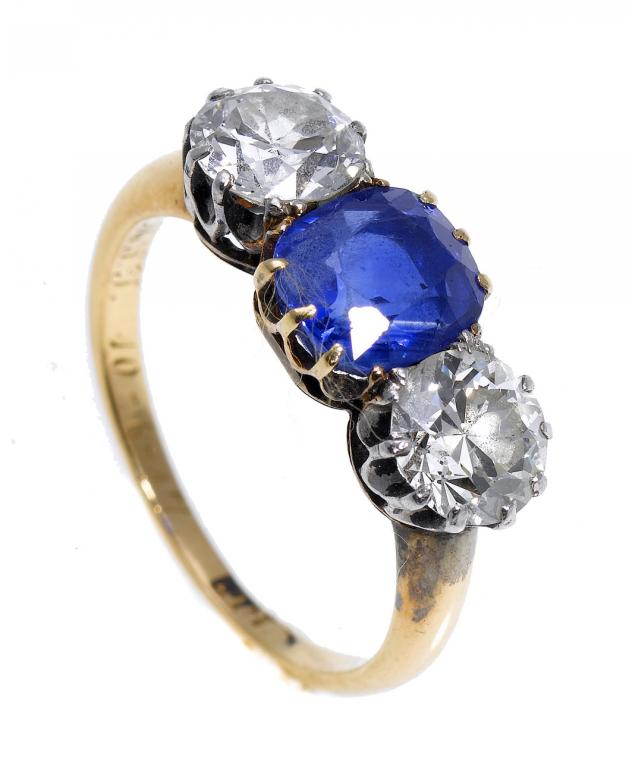 Appraisal: A SAPPHIRE AND DIAMOND THREE-STONE RING the slightly larger cushion