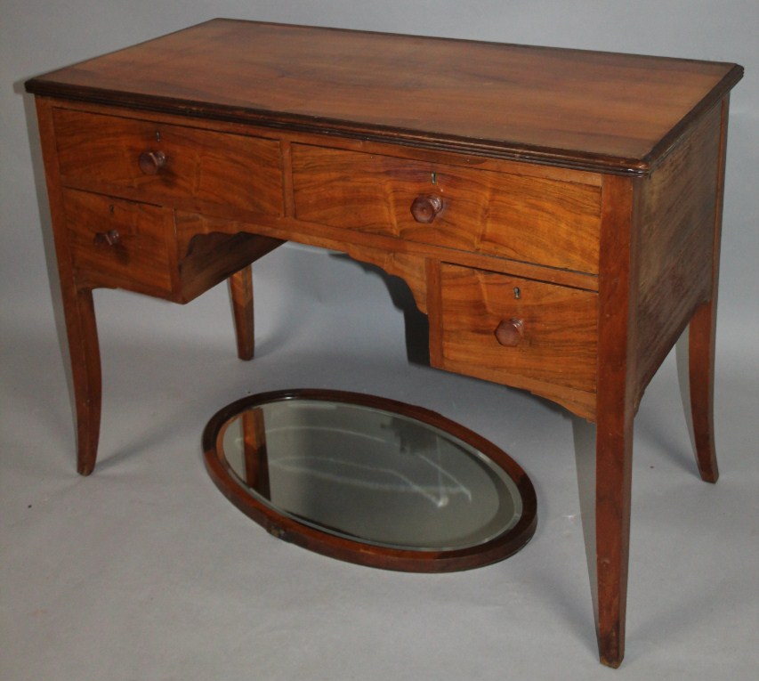 Appraisal: An Edwardian dressing table the rectangular overhanging top raised above