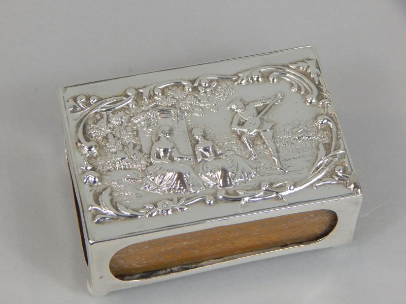 Appraisal: An Edwardian silver rectangular matchbox holder the lid cast with