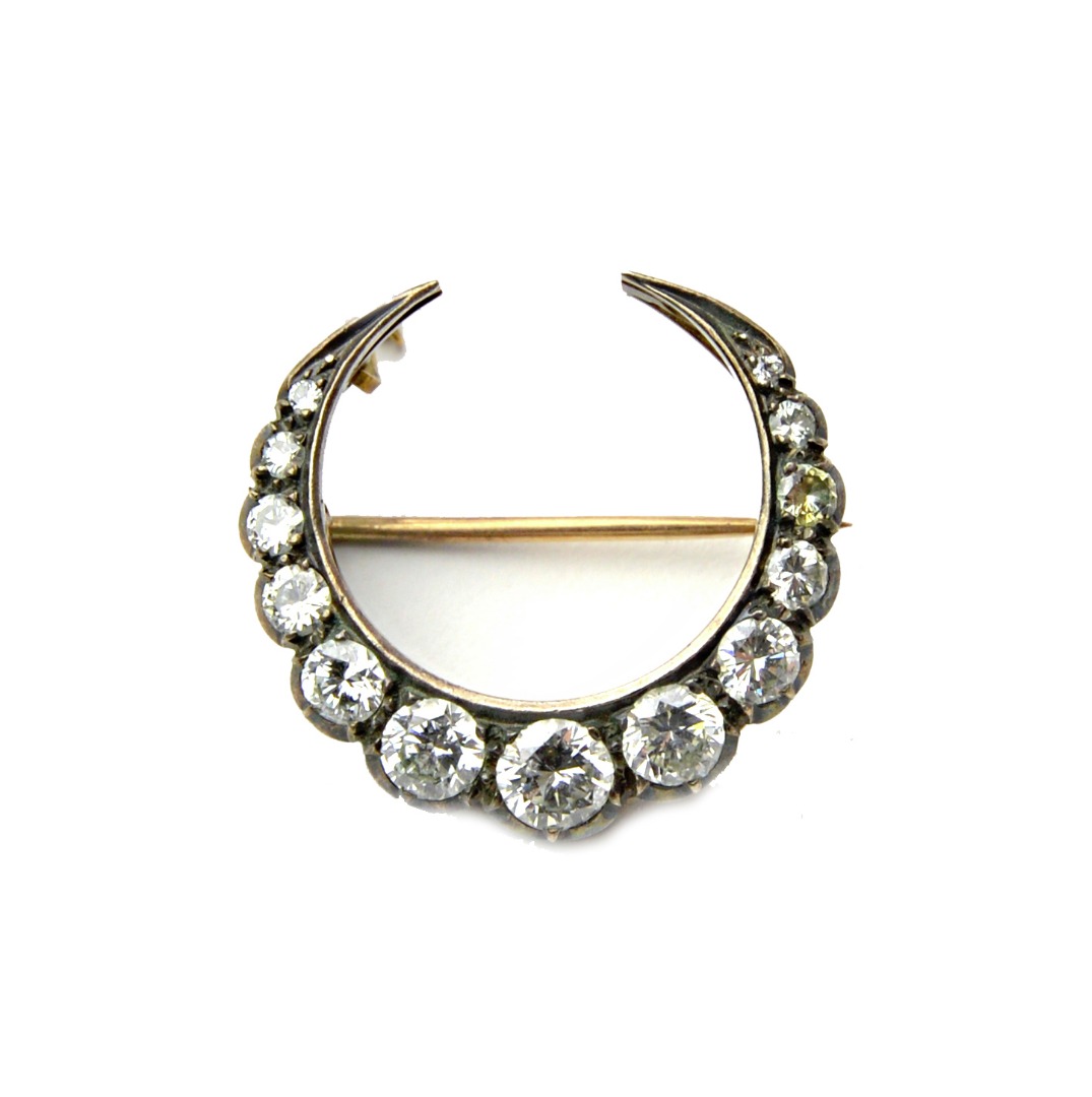 Appraisal: A diamond brooch designed as a crescent mounted with a