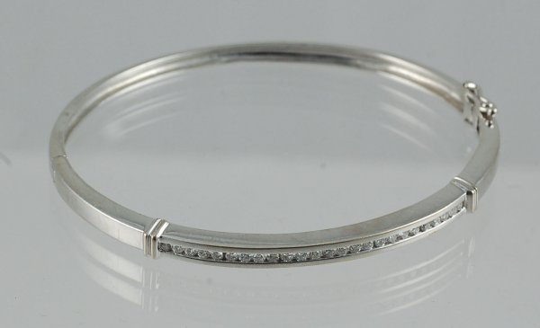 Appraisal: Channel set bangle in K stamped white gold Twenty-five round