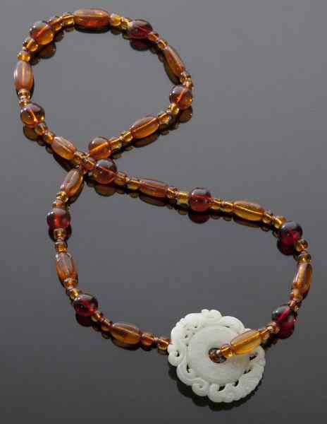 Appraisal: Chinese Qing red amber necklace with white jadependant depicting a