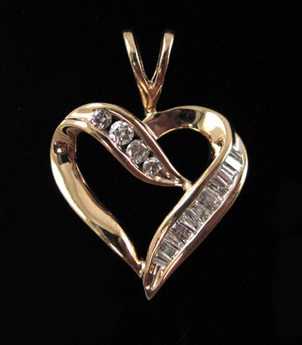 Appraisal: DIAMOND AND TEN KARAT GOLD PENDANT The yellow gold open