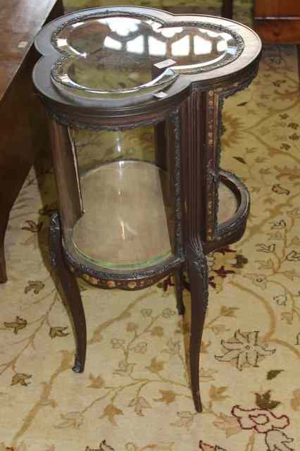 Appraisal: A FRENCH WALNUT BIJOUTERIE CABINET of tricorn form with curved