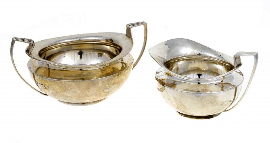 Appraisal: A GEORGE V CREAM JUG AND SUGAR BOWL compressed circular