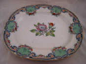 Appraisal: A ceramic meat dish with green and red rose centre