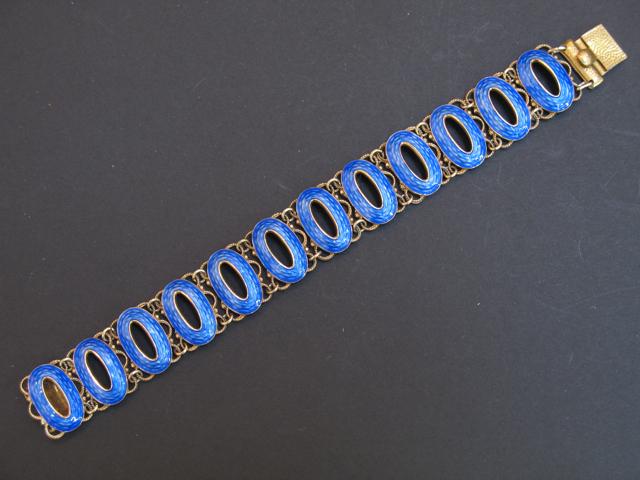 Appraisal: A CONTINENTAL SILVER GILT BRACELET each oval open-work blue guilloche