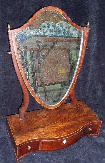 Appraisal: A th Century mahogany toilet mirror the shield shaped glass