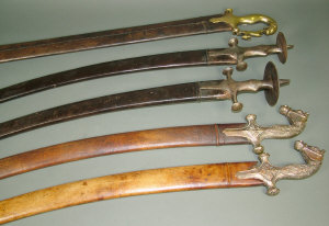 Appraisal: Two Indian tulwars the plated hilts with horse's head pommels