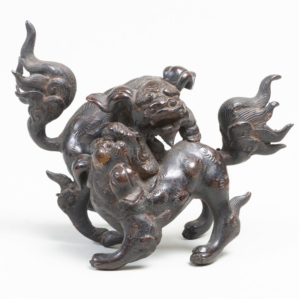 Appraisal: Japanese Bronze Figure of Playful Shishi in long Property from