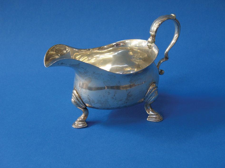 Appraisal: A GEORGE II CREAM BOAT of oval form with a