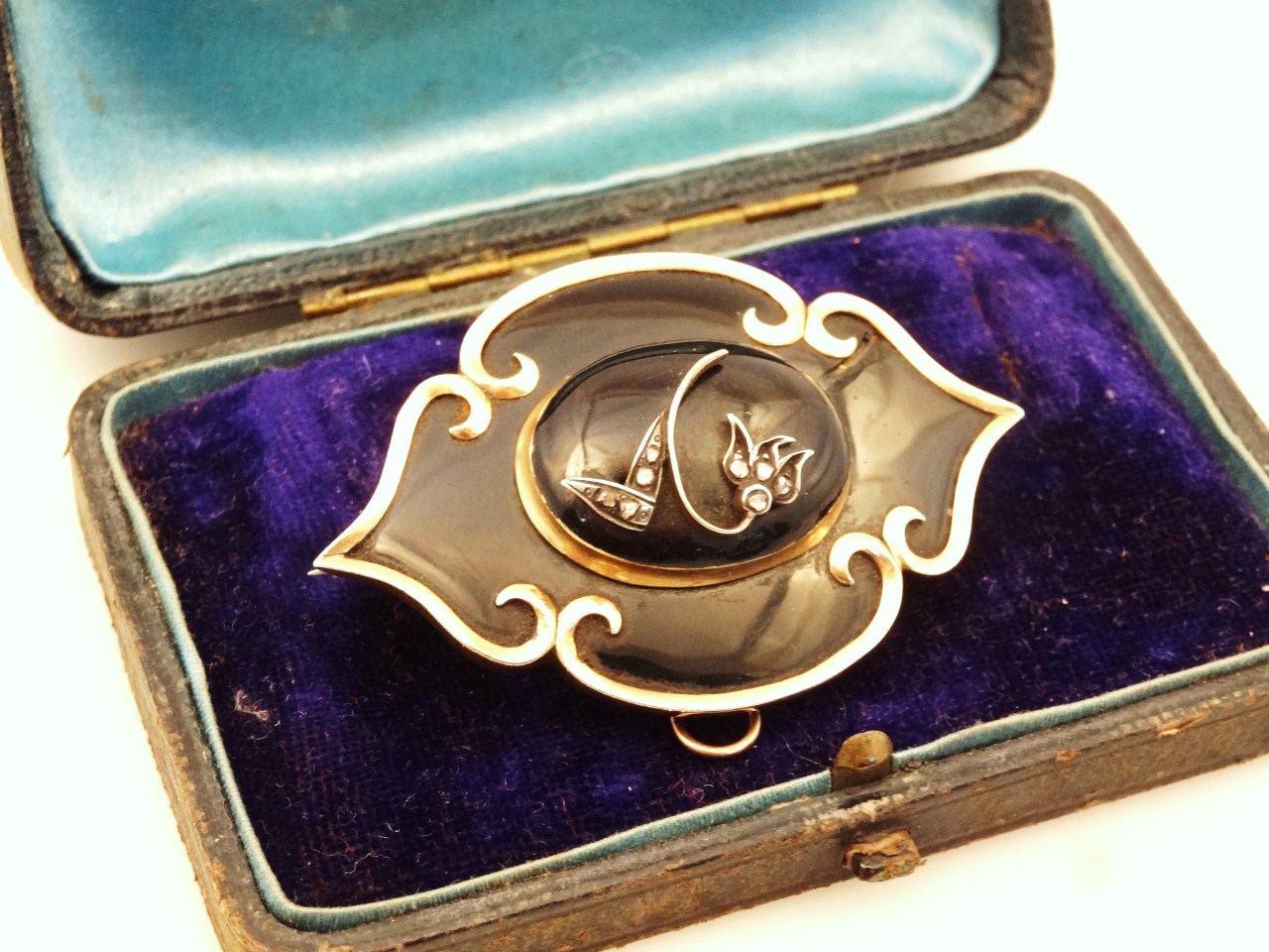 Appraisal: A Victorian mourning brooch of shaped outline with a raised