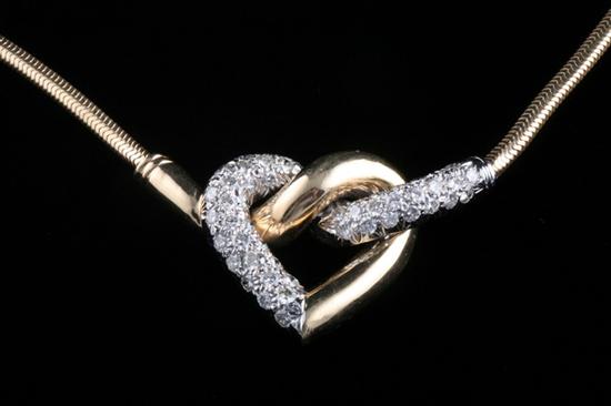 Appraisal: K YELLOW AND WHITE GOLD AND DIAMOND HEART MOTIF NECKLACE