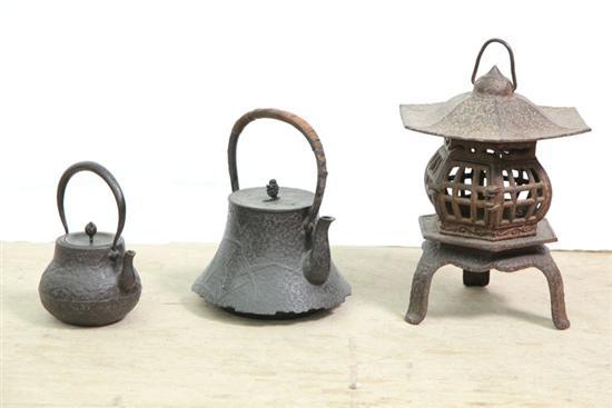 Appraisal: CAST IRON ASIAN TEAPOTS AND LANTERN Teapots have textured surface