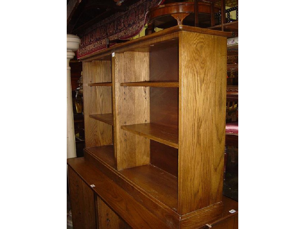 Appraisal: A contemporary oak dwarf frieze standing open bookcase enclosing four