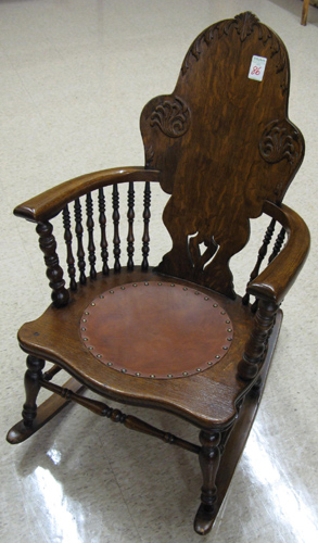 Appraisal: A VICTORIAN OAK ROCKING ARMCHAIR American c having a shaped