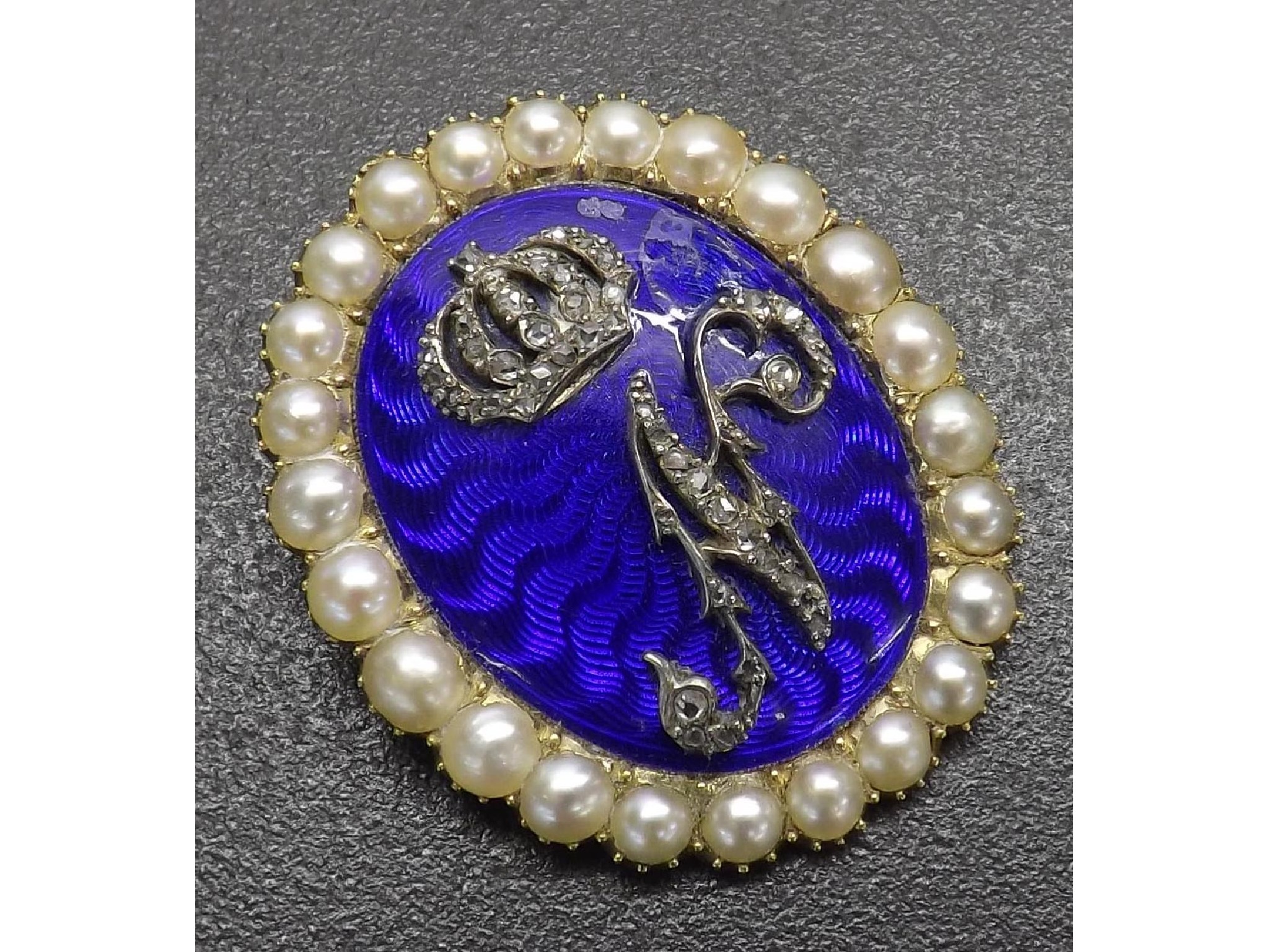 Appraisal: th century seed pearl and blue guilloche enamel brooch applied