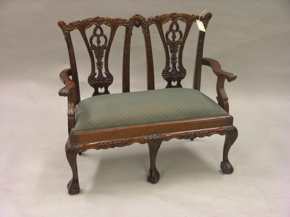 Appraisal: A reproduction Chippendale style twin chair-back settee with drop-in seat