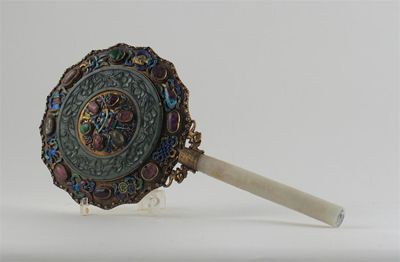 Appraisal: A Chinese hand mirror with a white jade handle the