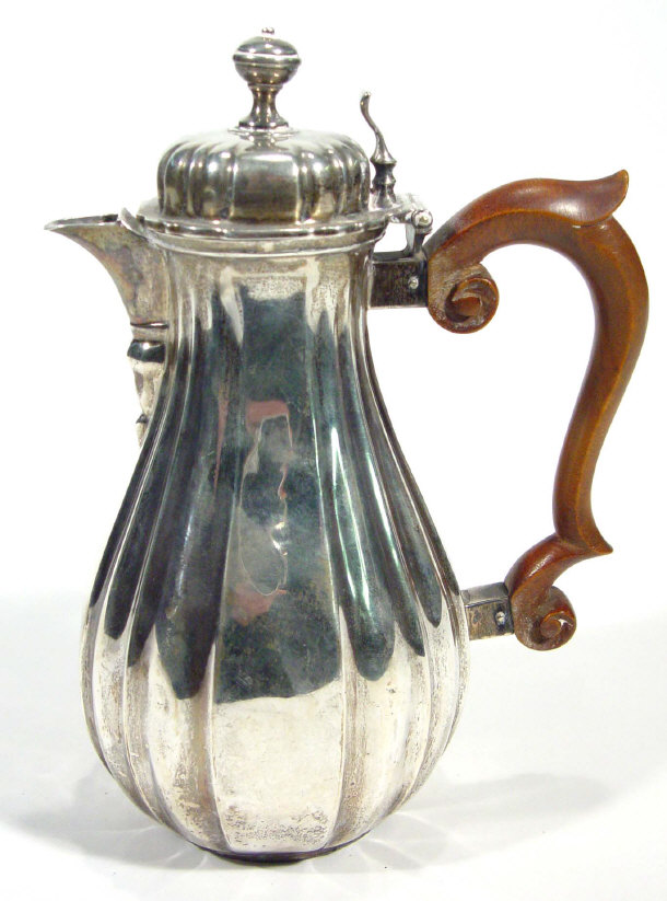 Appraisal: Fluted silver coffee pot with walnut handle London cm high