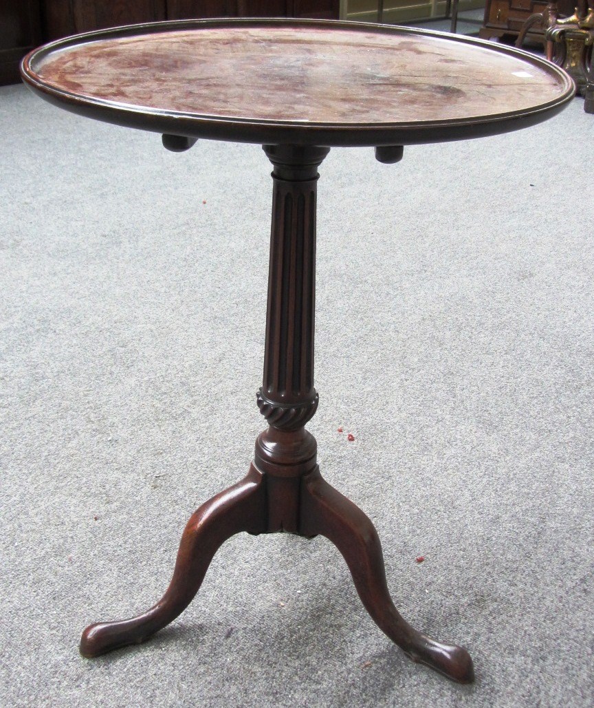 Appraisal: A th century circular mahogany occasional table on fluted tripod