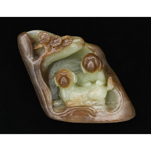 Appraisal: A Chinese jade pebble carving of two dogs in a