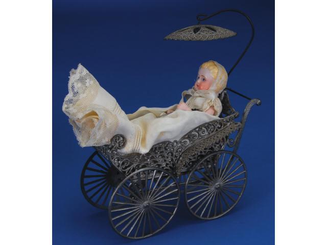 Appraisal: German Baby Doll with Soft Metal Carriage Germany ca soft