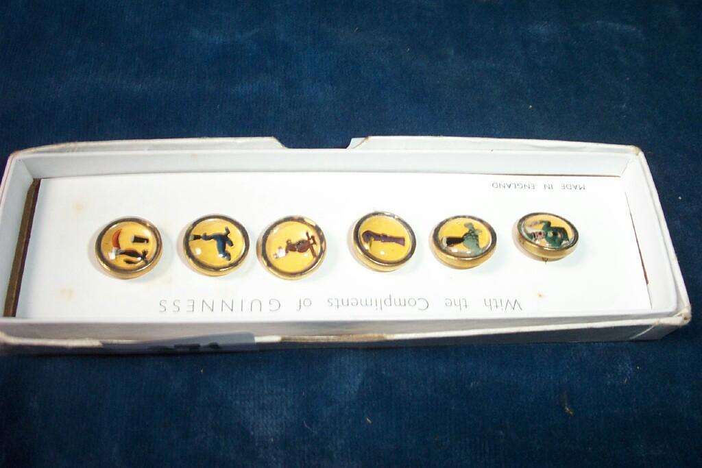 Appraisal: A set of six coloured Guinness buttons -