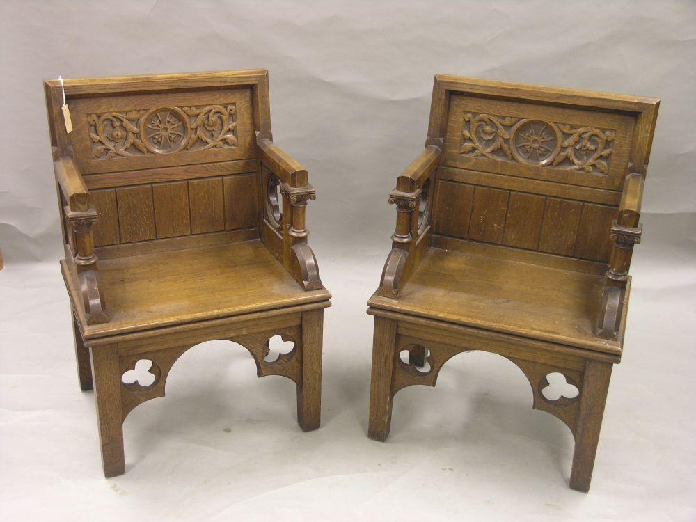 Appraisal: A pair of solid medium oak altar armchairs panelled backs