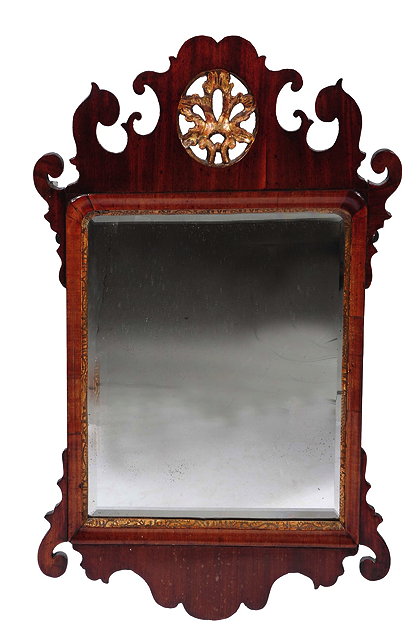 Appraisal: A GEORGE III MAHOGANY FRET FRAME HANGING WALL MIRROR with