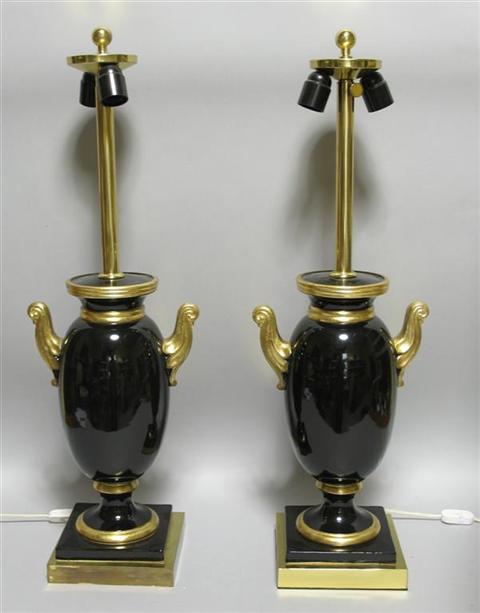 Appraisal: PAIR OF BLACK AND GILT URN-FORM LAMPS With scroll handles