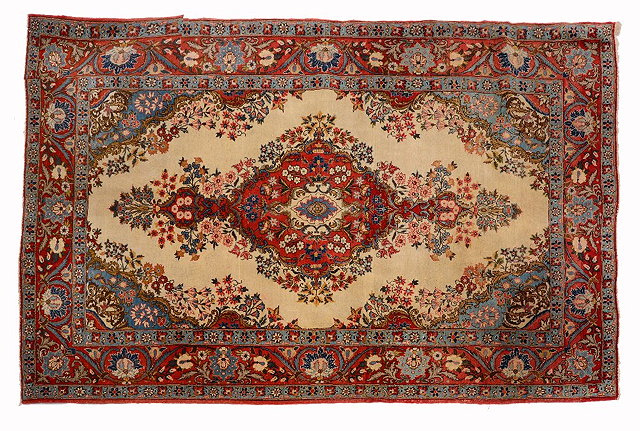 Appraisal: A PERSIAN QUM RUG with a central rust ground foliate