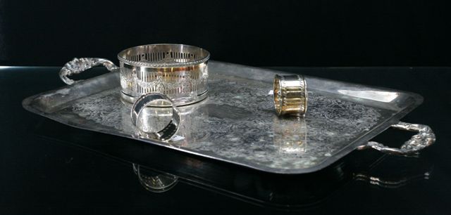 Appraisal: A Sheffield plated coaster together with four plated napkin rings