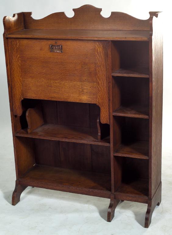 Appraisal: ARTS AND CRAFTS OAK LOW BUREAU BOOKCASE with shaped gallery