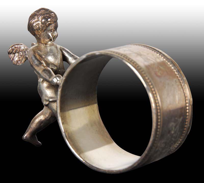 Appraisal: Winged Cherub Pushing Narrow Figural Napkin Ring Description No manufacturer's