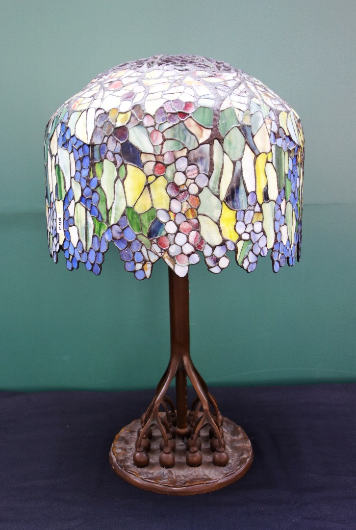 Appraisal: A bronze and coloured glass Tiffany style table lamp late