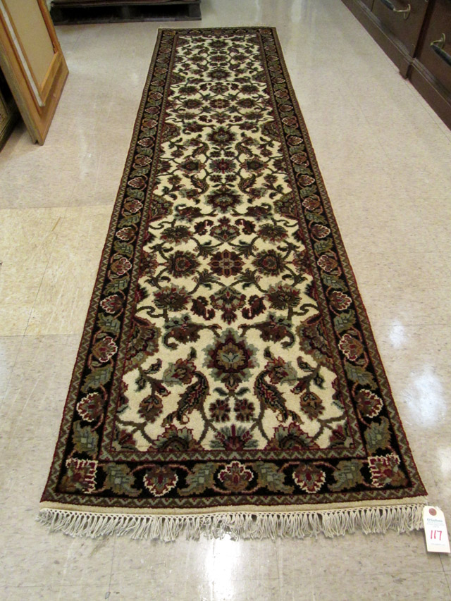 Appraisal: HAND KNOTTED ORIENTAL HALL RUG Indo-Persian featuring a colorful floral