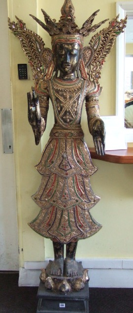 Appraisal: A Thai carved wood figure th century modelled as a