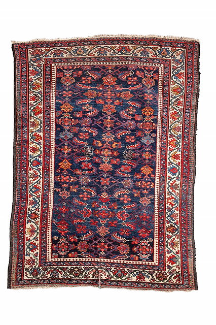 Appraisal: A HAMADAN BLUE GROUND RUG with stylised foliate and geometric