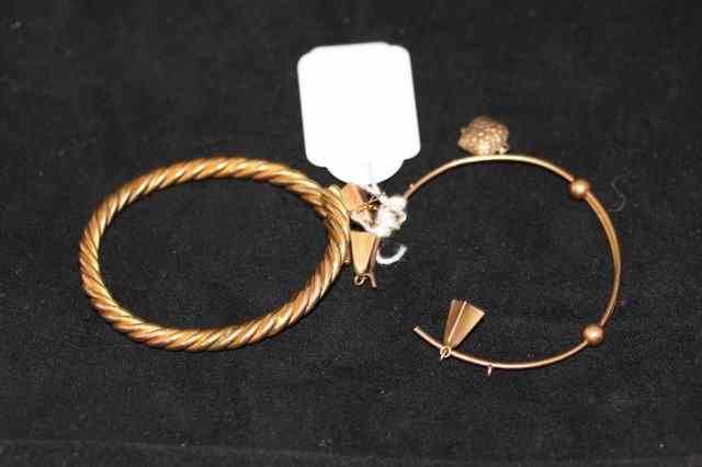 Appraisal: A HINGED BANGLE in a rope twist form and a