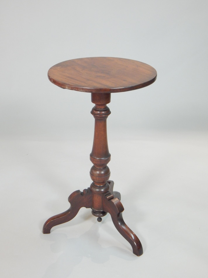 Appraisal: A Victorian walnut occasional top the circular top on turned